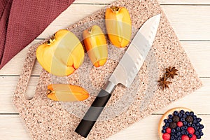 Ripe, juicy persimmon on a cutting board made of artificial stone