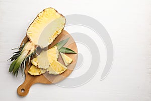 Ripe juicy pineapple on white wooden table, top view. Space for text