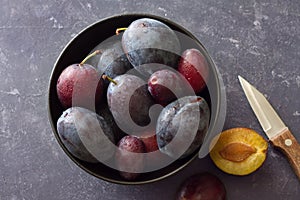 Ripe, juicy plums in bowl