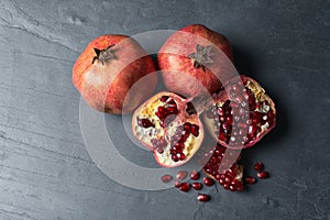 Ripe juicy pomegranates on grey background