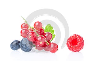 Ripe and juicy red currant berries with blueberry and raspberry isolated on white background. Healthy food mix.