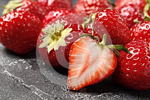 Ripe juicy strawberries on a dark background close-up