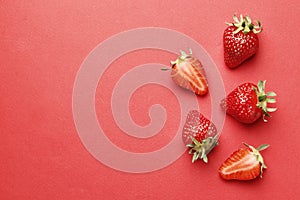 Ripe juicy strawberries on a red background