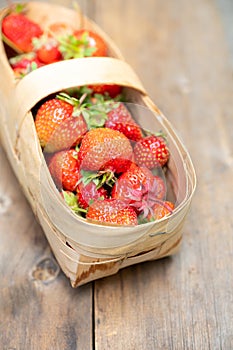 Ripe juicy strawberries in vintage basket