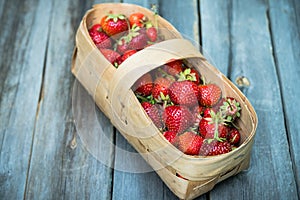 Ripe juicy strawberries in vintage basket