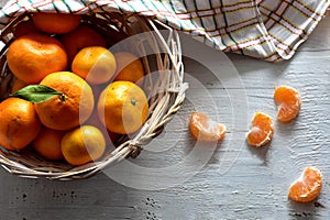Ripe juicy tangerines in a bowl. Tangerine leaves. Fresh fragrant mandarins. Harvest tangerines