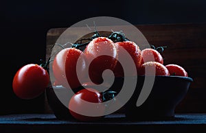 Ripe juicy tomatoes in a ceramic dish