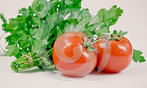 Ripe juicy tomatoes and green parsley in the kitchen