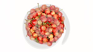 Ripe juicy yellow sweet cherries on plate. Side view. Clockwise rotation. Loop motion. Rotation 360.