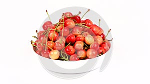 Ripe juicy yellow sweet cherries on plate. Side view. Clockwise rotation. Loop motion. Rotation 360.