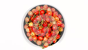 Ripe juicy yellow sweet cherries on plate. Top view. Clockwise rotation. Loop motion. Rotation 360.