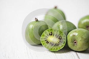 Ripe kiwi berries on a white table