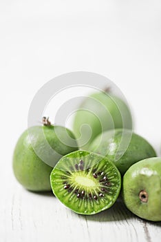 Ripe kiwi berries on a white table