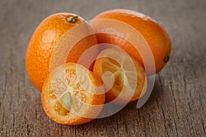 Ripe kumquat fruits on wooden table