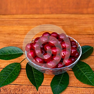 Ripe large juicy cherries in a transparent plate