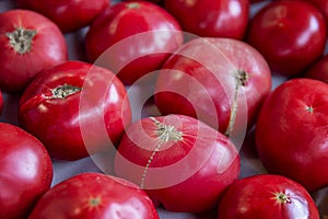 Ripe large tomatoes at the market. Top view. Healthy nutrition, vitamins and vegetarianism. Close-up