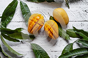 Ripe mangoes on white wood