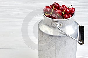 Ripe natural cherries in metal bucket.