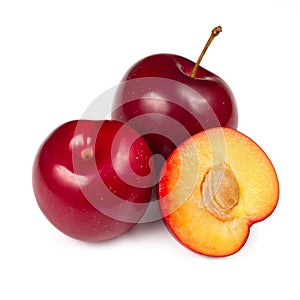 Ripe natural plums. In the foreground is half a plum.