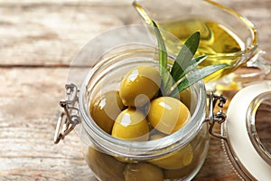 Ripe olives covered with oil in jar