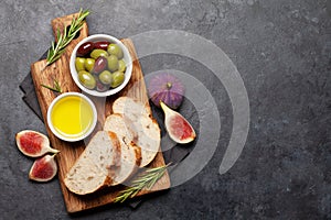 Ripe olives, figs, olive oil and ciabatta bread