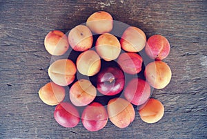 Ripe orange apricots on the rustic wooden table.