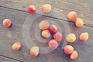 Ripe orange apricots on the rustic wooden table.