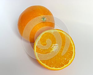 Ripe orange and its half. Isolated in a white background photo