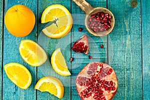 Ripe orange, pomegranate fruit on wooden vintage background. Healthy vegetarian food.