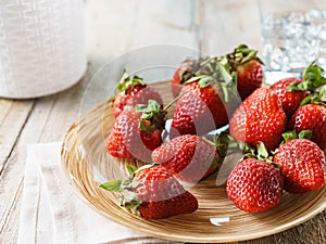 Ripe organic strawberries in a glass bowl.