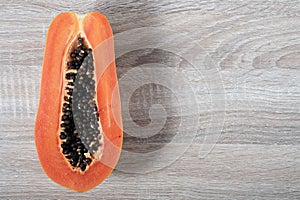 Ripe papaya with copyspace on wooden background.