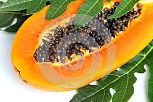 Ripe papaya with seeds and leaf