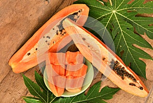 Ripe papaya on wood background.