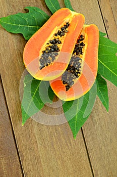 Ripe papaya on wood background.