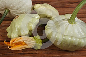 Ripe pattypan squash vegetables on a wooden