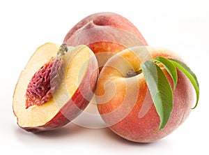 Ripe peach fruit with leaves and slises