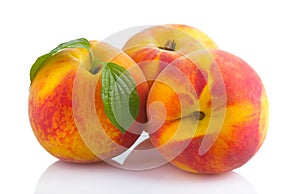 Ripe peach fruits with green leave isolated