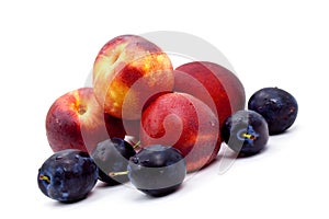 Ripe peach and Plums on a white Plate