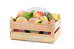 Ripe peaches in a wooden box