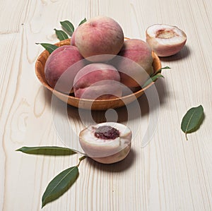 Ripe peaches on a wooden table