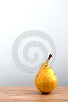 Ripe pear on desk