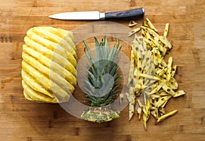 Ripe perfectly peeled pineapple, on a wooden background