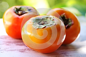 Ripe persimmon fruits on table