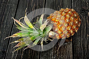 Ripe pineapple lies on a wooden table