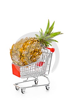 Ripe pineapple in shopping cart