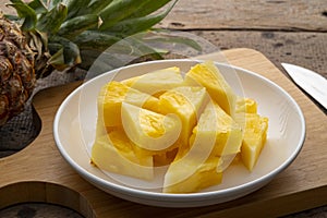Ripe pineapple slice on white plate