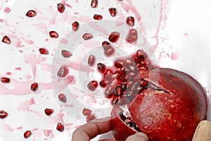 Ripe pomegranate fruit bursting close up.