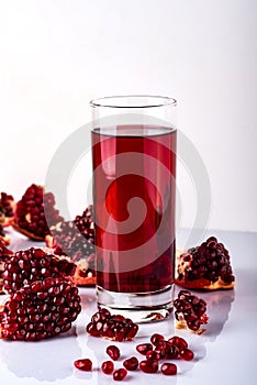 Ripe pomegranate fruit with leaves on white background.