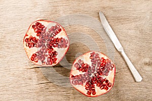 Ripe pomegranate fruit on wooden vintage background. Healthy vegetarian food.