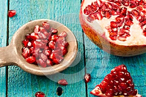 Ripe pomegranate fruit on wooden vintage background. Healthy vegetarian food.